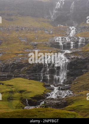 Dutzende kleine Rivuleten, die nach einem regnerischen Tag im Tal auf dem Weg nach Saksun, den Färöern, die Felsen hinunterströmen. Dänemark, Nordeuropa. Stockfoto