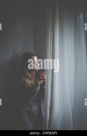 Kälte, Depressionen, junge Frau zu Hause, die sich traurig, einsam, ängstlich fühlt (farbiges Bild) Stockfoto