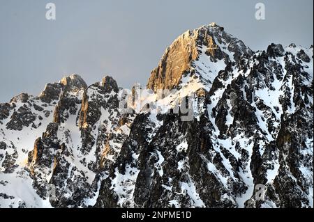Malerischer Blick auf die Vysoké Tatry über Starý Smokovec mit dem Gipfel Lomnický štít bei Sonnenuntergang mit felsigen Klippen Stockfoto