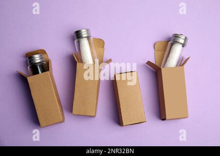 Flache Laienzusammensetzung mit natürlicher Zahnseide auf violettem Hintergrund Stockfoto