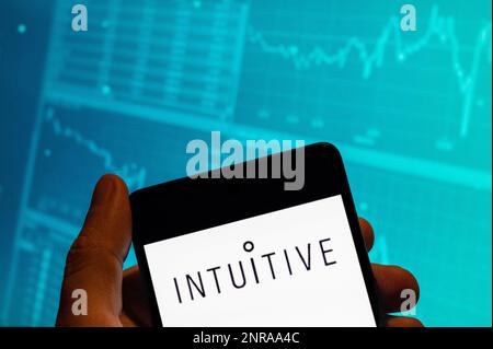 China. 15. Februar 2023. In dieser Fotoabbildung wird das amerikanische Unternehmen, das chirurgische Roboterprodukte entwickelt und herstellt, das intuitive Surgical Logo auf einem Smartphone mit einer Grafik des Börsenindex im Hintergrund angezeigt. (Kreditbild: © Budrul Chukrut/SOPA Images via ZUMA Press Wire) NUR REDAKTIONELLE VERWENDUNG! Nicht für den kommerziellen GEBRAUCH! Stockfoto