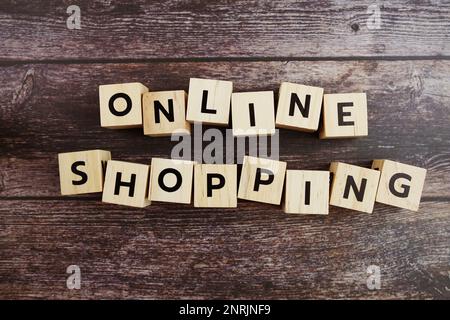 Online-Shopping – Buchstaben des Wortes auf Holzhintergrund Stockfoto