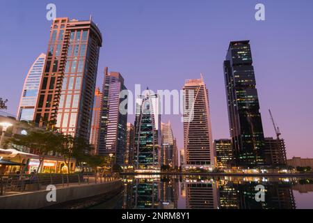 Dubai, VAE - 14. November 2019 - Panoramablick mit modernen Wolkenkratzern und Wasserpier der Dubai Marina bei Sonnenuntergang und Blue Hour. Vereinigte Arabische Emirate. Stockfoto