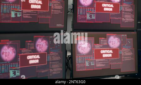 Leerer Schreibtisch mit mehreren Monitoren, die eine Systemabsturzwarnung anzeigen, kritische Fehlermeldung blinkt auf dem Bildschirm. Computer zeigt Sicherheitslücke und Hackerwarnung an, Computerfehler. Stockfoto
