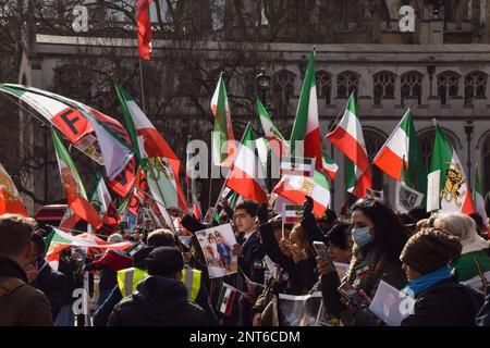 London, Großbritannien. 27. Februar 2023. Demonstranten halten während der Demonstration iranische Flaggen. Die Demonstranten veranstalteten auf dem Parlamentsplatz eine Kundgebung gegen das derzeitige iranische Regime und zur Unterstützung von Reza Pahlavi, dem Kronprinzen des Iran, als er das Unterhaus besuchte, um über die Zukunft des Iran zu diskutieren. (Foto: Vuk Valcic/SOPA Images/Sipa USA) Guthaben: SIPA USA/Alamy Live News Stockfoto