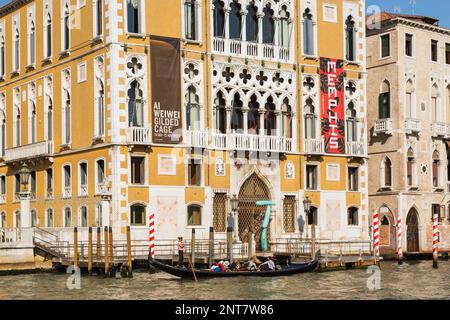 Gondoliere-Gondel mit Touristen auf dem Canale Grande vor dem Palast Cavalli-Franchetti im Renaissance-Stil, San Marco, Venedig, Italien. Stockfoto