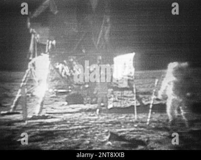 FILE - In this July 20, 1969 image made from television, Apollo 11 astronaut Neil Armstrong, right, trudges across the surface of the moon leaving behind footprints. The U.S. flag, planted on the surface by the astronauts, can be seen between Armstrong and the lunar module. Edwin E. Aldrin is seen closer to the craft. The men reported the surface of the moon was like soft sand and they left footprints several inches deep wherever they walked. (NASA via AP)
