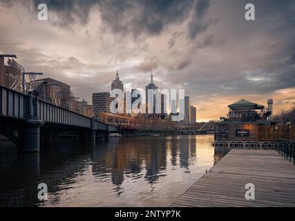 Melbourne, Victoria, Australien – zentraler Geschäftsbezirk von der Sandridge Bridge über den Yarra River in der Abenddämmerung aus gesehen Stockfoto