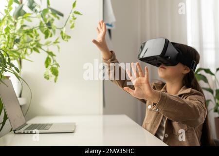 Schulmädchen im Teenageralter, die Virtual-Reality-Headsets verwenden Stockfoto