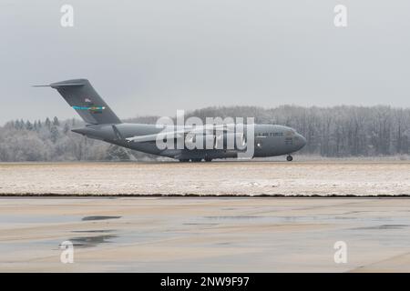 Ein C-17 Globemaster III startet am Dover Air Force Base, Delaware, 1. Februar 2023. Eine Spur Schnee fiel am Fuße, was das Ereignis als ersten Schneefall der Saison kennzeichnete. Stockfoto