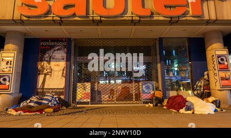 München, Deutschland. 01. März 2023. Obdachlose schlafen bei Temperaturen unter dem Gefrierpunkt am Eingang eines Ladens in der Innenstadt. Kredit: Peter Kneffel/dpa/Alamy Live News Stockfoto