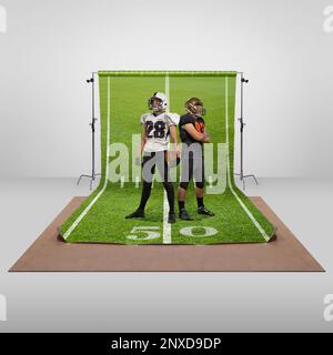 Champions. Zwei Männer, professionelle american Football-Spieler in Uniform, posieren vor dem Hintergrund eines Sportspielplatzes. Sportbegriff Stockfoto