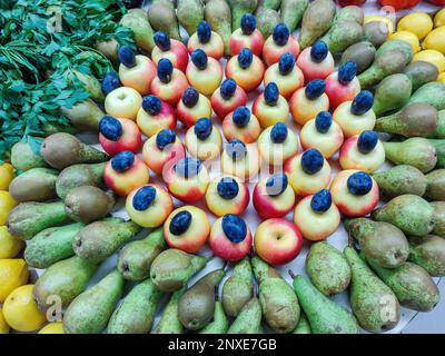 Wunderschöne Obst- und Gemüsedekoration. Birnen, Äpfel, Pflaumen, Zitronen, Petersilie, Aubergine Stockfoto