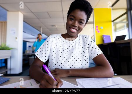 Porträt einer glücklichen afroamerikanischen Geschäftsfrau, die im Amt lächelt Stockfoto