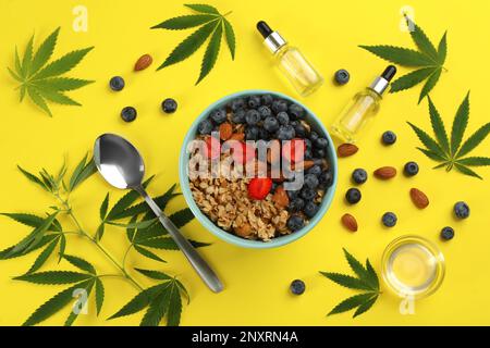 CBD-Öl, THC-Tinktur, Hafermehlschale und Hanfblätter auf gelbem Hintergrund, flach gelegt Stockfoto