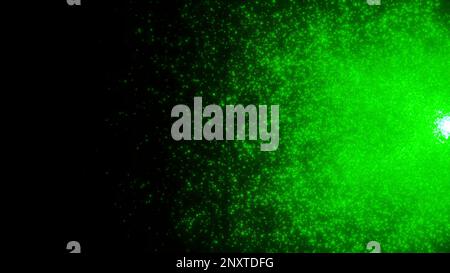 Dunkler Hintergrund. Bewegung. Ein fliegendes kleines Glitzern in 3D-Animation in lila und grüner Farbe. Hochwertige 4K-Aufnahmen Stockfoto