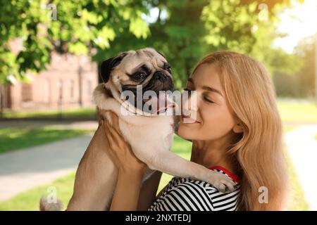 Frau mit süßem Hund im Freien an sonnigen Tagen. Adoption von Tieren Stockfoto