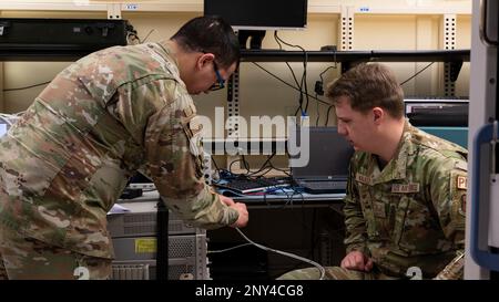 USA Air Force Senior Airman Joshua Pouncey, 49. Bauteilinstandhaltungsteam, Physical Dimensionstechniker, links, trainiert die USA Air Force Senior Airman Walker, 49. CMS Physical Dimensionician, über die Verwendung eines Joint Services Electronic Combat Systems Tester am Luftwaffenstützpunkt Holloman, New Mexico, 6. Januar 2023. Flugzeuge des Laborflugs mit Präzisionsmessgeräten sind für die Kalibrierung der von den Instandhaltern des Luftfahrzeugs verwendeten Ausrüstung verantwortlich, um sicherzustellen, dass sie funktionsfähig ist und auf die genauen Messwerte eingestellt ist. Stockfoto