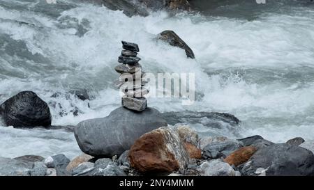 Riesige Wasserströme strömen flussabwärts. Kreativ. Nahaufnahmen mit kaltem Wasser, das gegen die Felsen des Bodens schlägt. Hochwertige 4K Meter Stockfoto