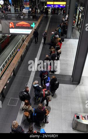 Passengers queue in the main train station in Berlin, Friday, Oct. 6, 2017. Seven people died Thursday as high winds knocked over trees and caused widespread travel chaos in northern Germany. Train connections in several northern states were shut down, including links to and from Berlin, because of the danger from branches over the tracks. Germany rail company Deutsche Bahn opened stationary trains to travelers left stranded by cancellations. (Maurizio Gambarini/dpa via AP)