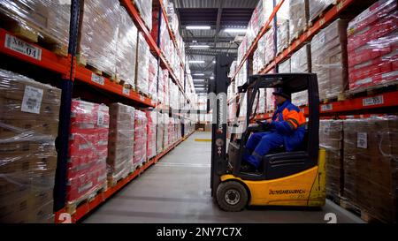 Serbien - Belgrad, 25. August 2022: Personen und Fahrzeuge arbeiten in einem Lager. Kreativ. Industrielles Produktionskonzept, hohe Arbeitseffizienz Stockfoto