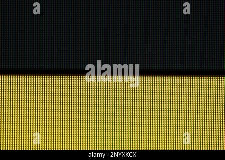 Schwarze und gelbe Streifen, Linien, LCD-TV-Bildschirm-Monitorpixel, extreme Nahaufnahme, abstrakte Hintergrundstruktur für Digitalanzeige in zwei Farben p Stockfoto