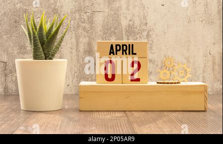 2. April auf grauen Holzwürfeln. Kalenderdatum des Cubes 02. April. Konzept des Datums. Platz für Text oder Ereignis kopieren. Lernwürfel. Holzblöcke im Karton mit d Stockfoto