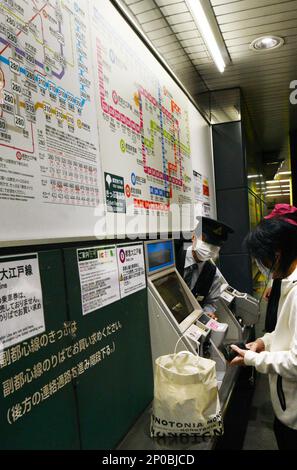 Fahrkartenautomat und menschliche Unterstützung an einem U-Bahn-Schalter in Tokio in Shinjuku, Tokio, Japan. Stockfoto