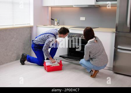 Wartungstechniker, Der Die Ofenanlage Wartet. Küchenreparatur Stockfoto