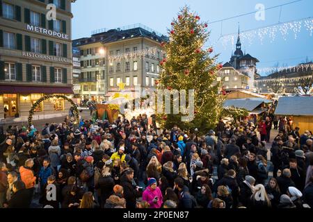 People enjoy the Christmas market on the Waisenhausplatz square in Bern, Switzerland, on Friday, Dec. 23, 2016. (Anthony Anex/Keystone via AP)