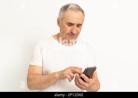 Älterer, reifer Rentner, der sich verzweifelt fühlt, am Telefon telefoniert, Probleme hat, Schulden, gestresster, trauriger Mann mittleren Alters, deprimiert durch schlechtes Hören Stockfoto