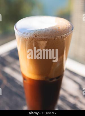 Eine Tasse griechischer eiskalter Kaffee auf einem Tisch, Frappe, ein Glas Freddo, Fredo Capuchino serviert in der Taverne des Straßencafés, auf der Insel Korfu, Kerkyra, Griechenland, griechisch Stockfoto
