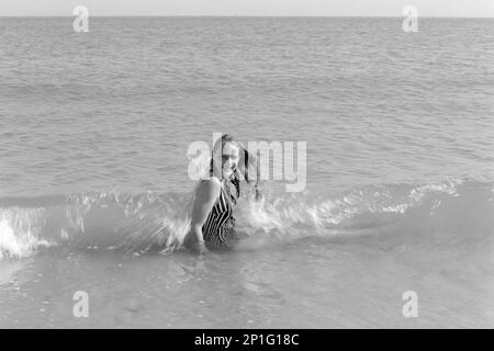 Junge, hübsche, blonde Frau im Meer in southsea england, uk 1990er Stockfoto