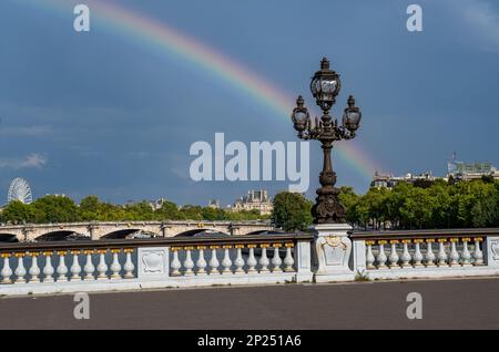 Brücke Pont Alexandre III über die seine mit farbenfrohem Regenbogen in Paris, Frankreich Stockfoto