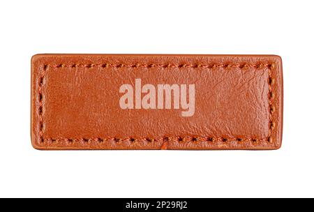Lange braune Lederjeans, Etikett isoliert auf weiß, Draufsicht Stockfoto