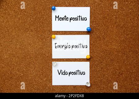 Weiße und mehrfarbige Hinweise auf Korktafel mit Botschaft in spanischer Sprache „positiver Geist, positive Energie, positives Leben“ Stockfoto