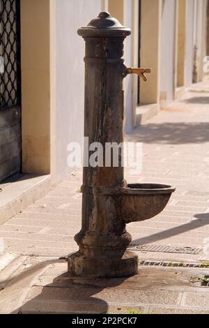 Galatina, Italien. Öffentlicher Brunnen auf einem Gehweg im historischen Zentrum. Stockfoto