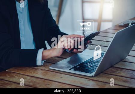 Zwei-Stufen-Authentifizierung (2FA) Konzept. Schlüsselsymbol und Passwortcode werden auf dem Smartphone angezeigt, während sich ein Geschäftsmann auf einem Laptop anmeldet, Identitätsveri Stockfoto