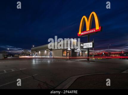 Hobbs, New Mexico, USA – 21. Februar 2023: Verschwommene Fahrzeuge fahren am frühen Morgen durch McDonald's Drive-Thru Stockfoto