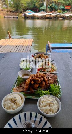 Ein Tisch mit thailändischem Isaan Landessen in Thailand am Abend Stockfoto