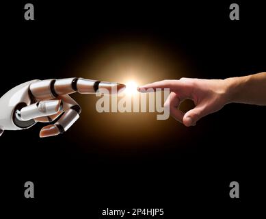 Eine Roboterhand zeigt auf eine menschliche Hand. Das Konzept der künstlichen Intelligenz. Stockfoto