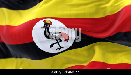 Uganda-Nationalflagge winkt. Sechs horizontale Streifen in Schwarz, Gelb und Rot. Weiße Scheibe mit grauem Kranich in der Mitte. Texturiertes Bac Stockfoto