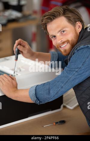 Glücklicher Mann bei der Reparatur des wlan-Routers Stockfoto