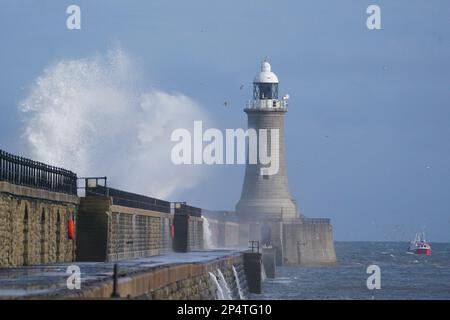 Wellen stürzen über dem Leuchtturm am Tynemouth Pier an der Mündung des Flusses Tyne in Nordostengland. Foto: Montag, 6. März 2023. Stockfoto