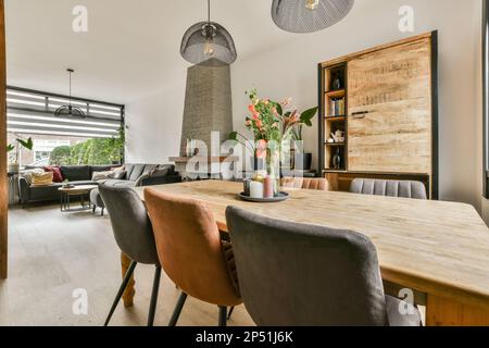 Amsterdam, Niederlande - 10. April 2021: Ein Speisesaal mit Stühlen und einem Tisch vor der Wand aus Holzplanken Stockfoto