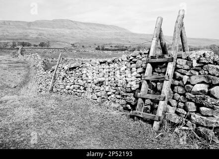 Leiterstiel über einer Wand auf einem kreisförmigen Spaziergang unter Whernside und in der Nähe des Ribblehead Viadukt. Stockfoto