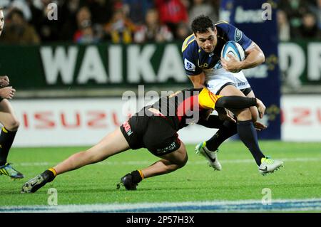 Ross Kerr Rugby Brumbies' George Smith, right, slips the tackle of Chiefs' Tawera Kerr ...