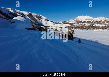 Blick auf das schneebedeckte Skigebiet Mammoth Mountain mit blauem Himmel nach einem Rekordschneefall. Stockfoto