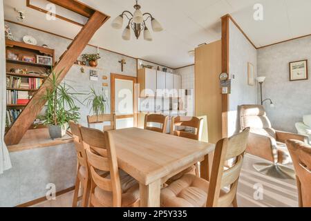 Eine Küche und Essbereich in einem Haus mit einer offenen Treppe, die zum Wohnzimmer im zweiten Stock führt Stockfoto
