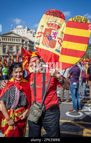 Katalanische Demonstranten gegen die Unabhängigkeit tragen während einer Demonstration für die Einheit Spaniens anlässlich der spanischen Natio die spanische und katalanische Flagge Stockfoto